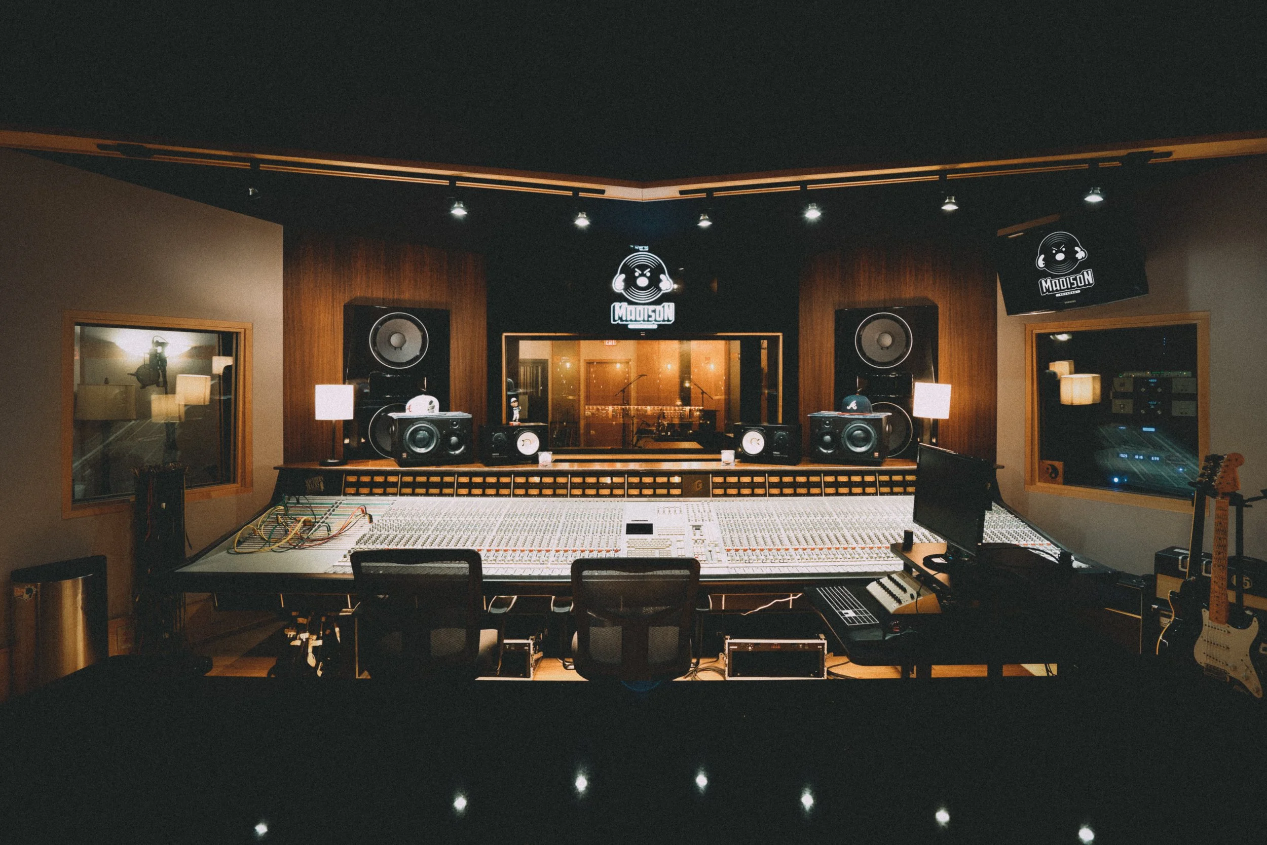 Professional recording studio with mixing console, monitors, and warm lighting